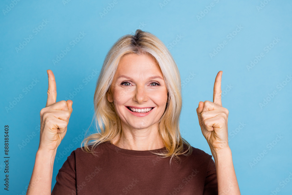 Photo of lovely gorgeous woman wear trendy brown clothes presenting empty space isolated on blue color background Photo of lovely gorgeous woman wear trendy brown clothes presenting empty space isolated on blue color background