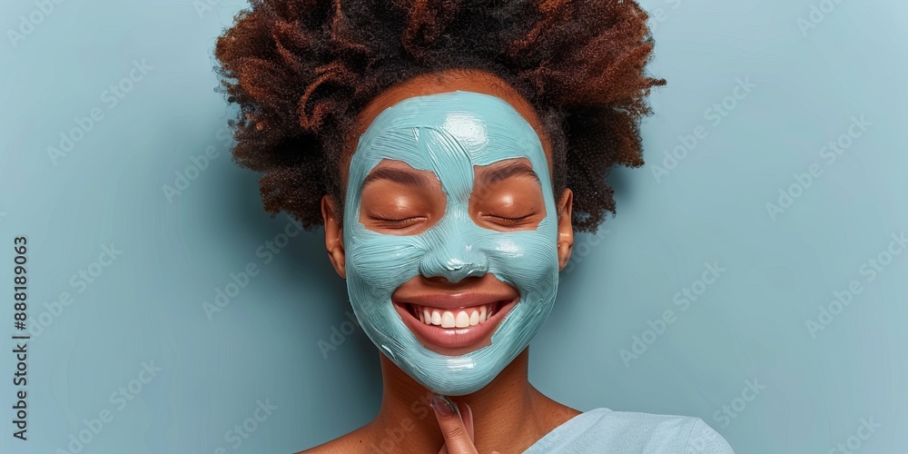 Happy woman applying blue face mask, skin care and beauty treatment, natural skincare concept Happy woman applying blue face mask, skin care and beauty treatment, natural skincare concept