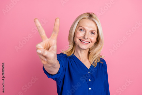 Wallpaper Mural Photo portrait of pretty senior female show v-sign wear trendy blue outfit isolated on pink color background Torontodigital.ca