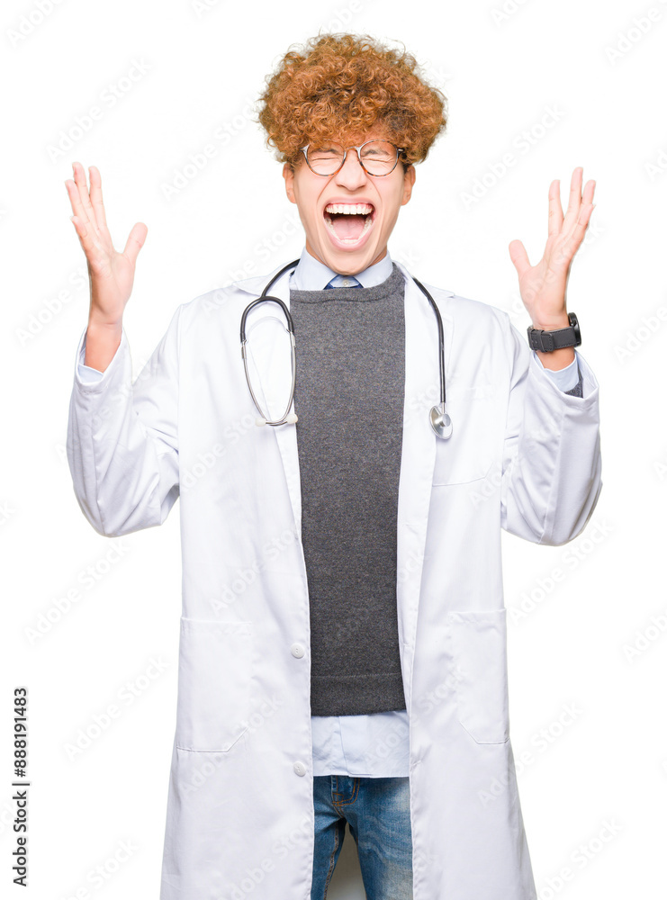 Young handsome doctor man wearing medical coat celebrating mad and crazy for success with arms raised and closed eyes screaming excited. Winner concept Young handsome doctor man wearing medical coat celebrating mad and crazy for success with arms raised and closed eyes screaming excited. Winner concept