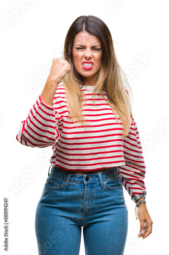 Young beautiful woman casual stripes winter sweater over isolated background angry and mad raising fist frustrated and furious while shouting with anger. Rage and aggressive concept.