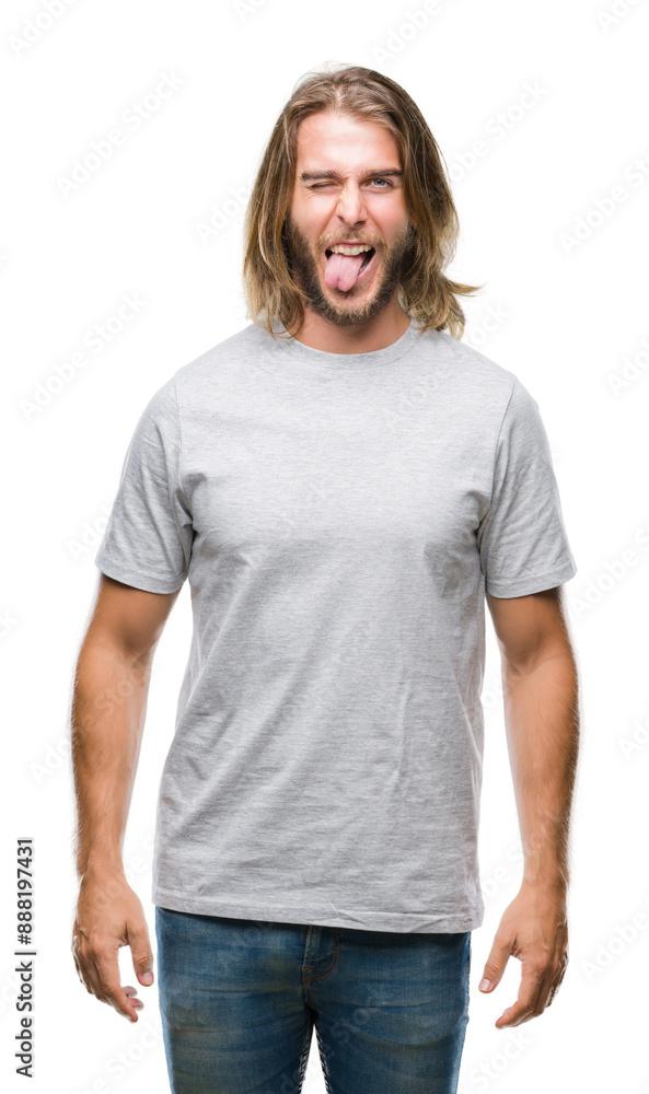 Young handsome man with long hair over isolated background sticking tongue out happy with funny expression. Emotion concept. Young handsome man with long hair over isolated background sticking tongue out happy with funny expression. Emotion concept.
