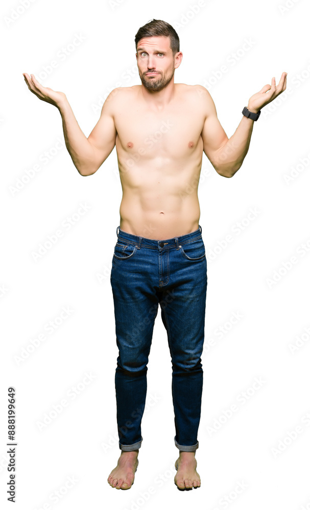 Handsome shirtless man showing nude chest clueless and confused expression with arms and hands raised. Doubt concept. Handsome shirtless man showing nude chest clueless and confused expression with arms and hands raised. Doubt concept.