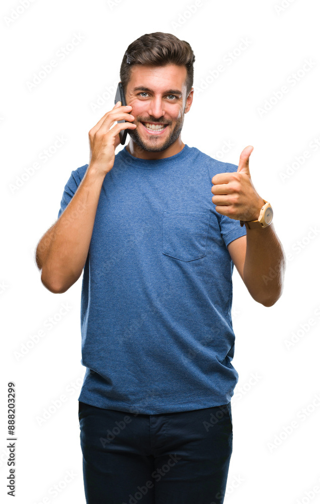 Young handsome man talking on smartphone over isolated background happy with big smile doing ok sign, thumb up with fingers, excellent sign Young handsome man talking on smartphone over isolated background happy with big smile doing ok sign, thumb up with fingers, excellent sign