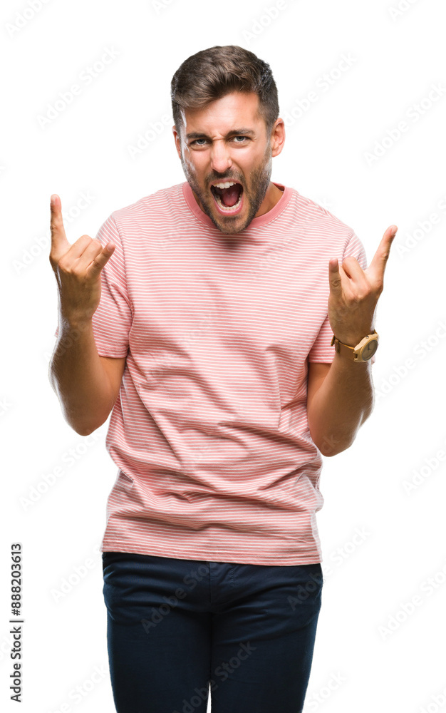 Young handsome man over isolated background shouting with crazy expression doing rock symbol with hands up. Music star. Heavy concept. Young handsome man over isolated background shouting with crazy expression doing rock symbol with hands up. Music star. Heavy concept.