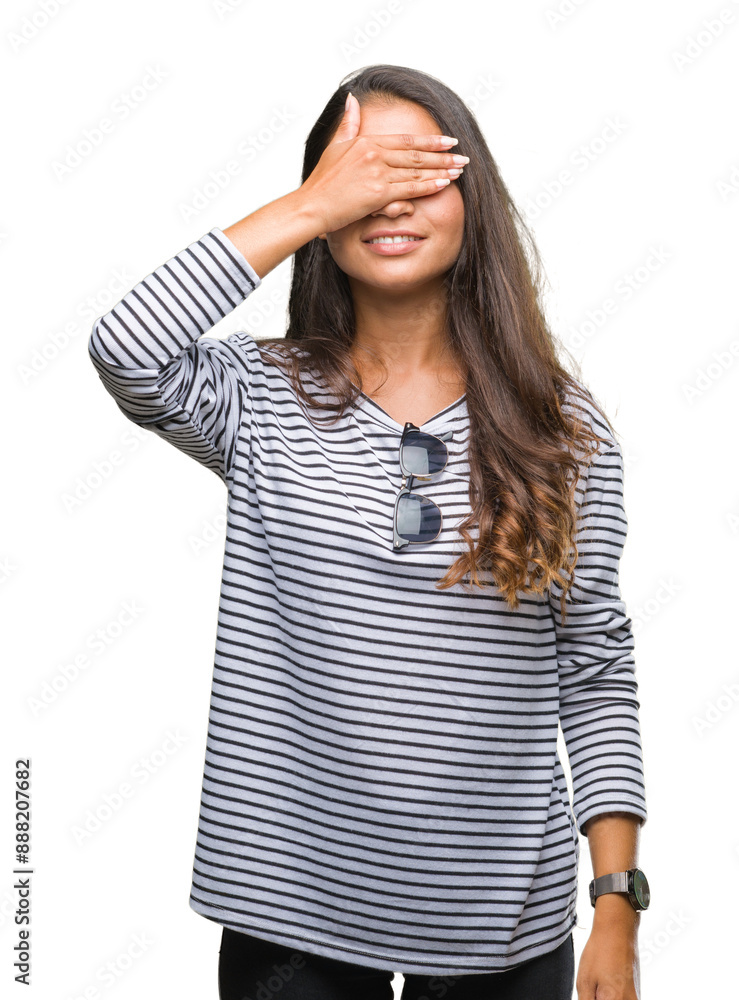 Young beautiful arab woman wearing sunglasses over isolated background smiling and laughing with hand on face covering eyes for surprise. Blind concept. Young beautiful arab woman wearing sunglasses over isolated background smiling and laughing with hand on face covering eyes for surprise. Blind concept.