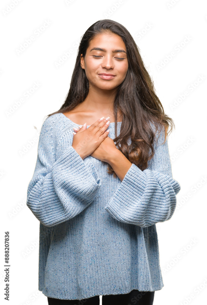 Young beautiful arab woman wearing winter sweater over isolated background smiling with hands on chest with closed eyes and grateful gesture on face. Health concept. Young beautiful arab woman wearing winter sweater over isolated background smiling with hands on chest with closed eyes and grateful gesture on face. Health concept.