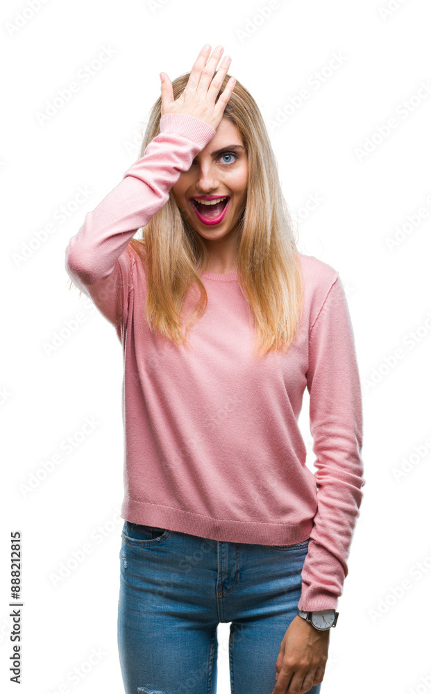 Young beautiful blonde woman wearing pink winter sweater over isolated background surprised with hand on head for mistake, remember error. Forgot, bad memory concept. Young beautiful blonde woman wearing pink winter sweater over isolated background surprised with hand on head for mistake, remember error. Forgot, bad memory concept.