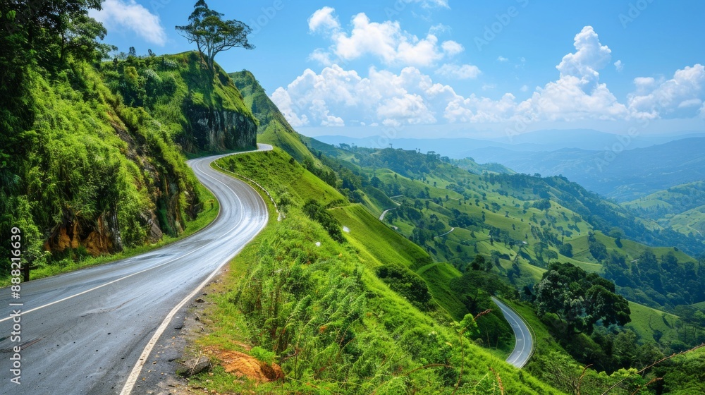 A winding mountain road cutting through lush, green hills. The road twists and turns, offering stunning views of the landscape below, with a clear blue sky overhead. A winding mountain road cutting through lush, green hills. The road twists and turns, offering stunning views of the landscape below, with a clear blue sky overhead.
