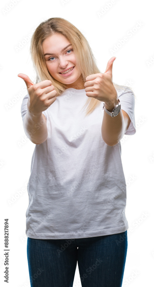 Young caucasian woman over isolated background approving doing positive gesture with hand, thumbs up smiling and happy for success. Looking at the camera, winner gesture. Young caucasian woman over isolated background approving doing positive gesture with hand, thumbs up smiling and happy for success. Looking at the camera, winner gesture.