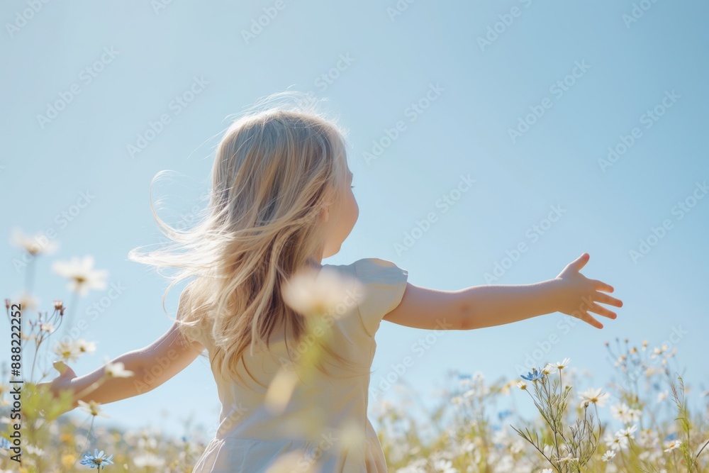 Blonde girl in summer dress walking through a wildflower field under clear blue sky, natural beauty concept Blonde girl in summer dress walking through a wildflower field under clear blue sky, natural beauty concept