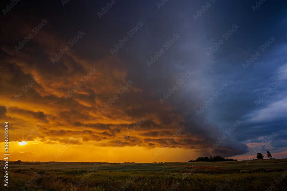Dramatic sunset thunderstorm sky over an open field Dramatic sunset thunderstorm sky over an open field