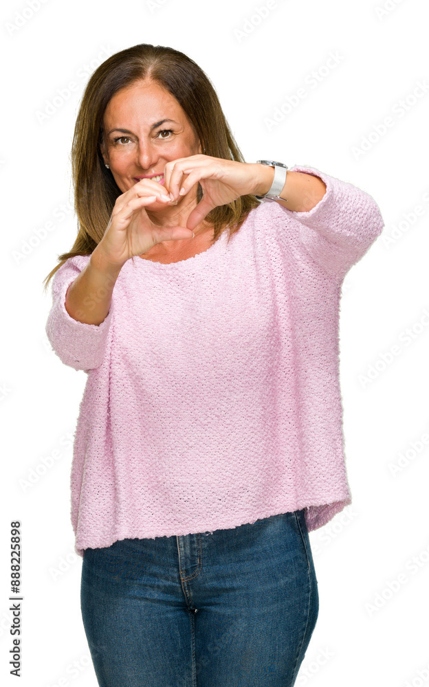 © Krakenimages.com - Beautiful middle age adult woman wearing winter sweater over isolated background smiling in love showing heart symbol and shape with hands. Romantic concept.