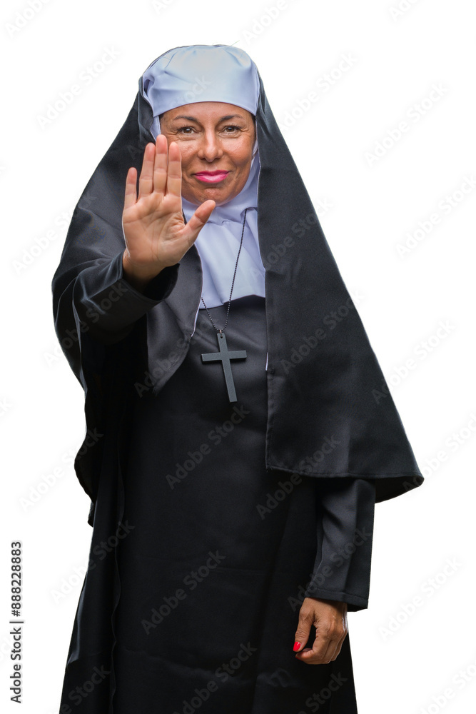 Middle age senior christian catholic nun woman over isolated background doing stop sing with palm of the hand. Warning expression with negative and serious gesture on the face. Middle age senior christian catholic nun woman over isolated background doing stop sing with palm of the hand. Warning expression with negative and serious gesture on the face.