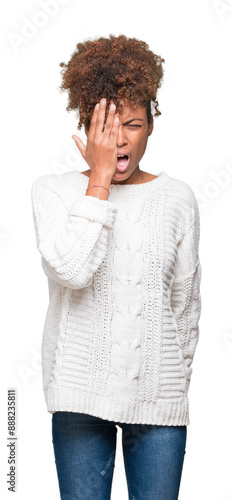 Beautiful young african american woman wearing winter sweater over isolated background Yawning tired covering half face, eye and mouth with hand. Face hurts in pain.