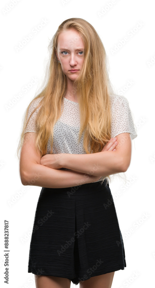Blonde teenager woman wearing moles shirt skeptic and nervous, disapproving expression on face with crossed arms. Negative person. Blonde teenager woman wearing moles shirt skeptic and nervous, disapproving expression on face with crossed arms. Negative person.