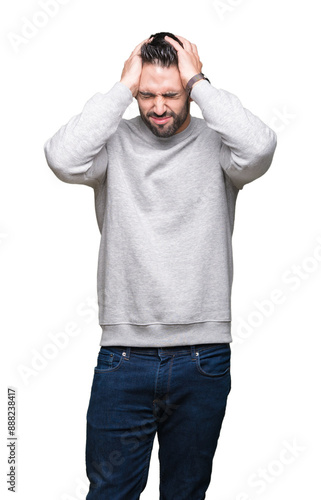 Obraz na plátně Young handsome man wearing sweatshirt over isolated background suffering from headache desperate and stressed because pain and migraine