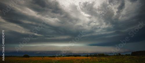 Supercell cloud with distant lightning illuminating the storm structure © lukjonis