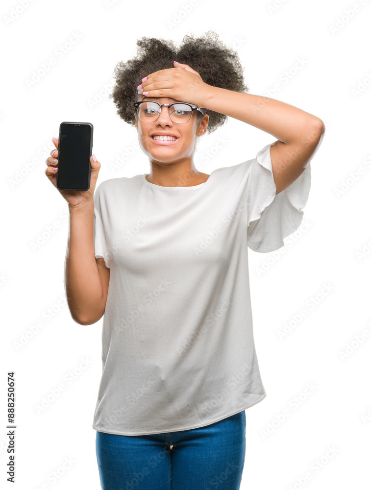 Young beautiful afro american showing smartphone screen over isolated background stressed with hand on head, shocked with shame and surprise face, angry and frustrated. Fear and upset for mistake. Young beautiful afro american showing smartphone screen over isolated background stressed with hand on head, shocked with shame and surprise face, angry and frustrated. Fear and upset for mistake.