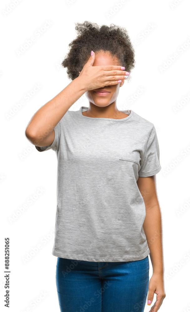 Young afro american woman wearing glasses over isolated background smiling and laughing with hand on face covering eyes for surprise. Blind concept. Young afro american woman wearing glasses over isolated background smiling and laughing with hand on face covering eyes for surprise. Blind concept.