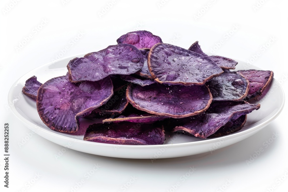 Crispy and sweet purple sweet potato chips on a white plate close up Crispy and sweet purple sweet potato chips on a white plate close up