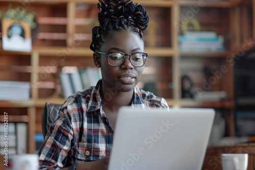 Young African American Woman Teaching Online from Home on Laptop photo