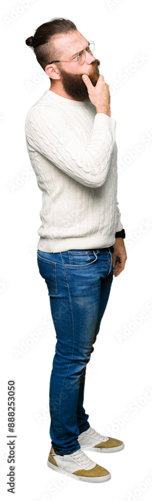 Young hipster man wearing glasses and winter sweater with hand on chin thinking about question, pensive expression. Smiling with thoughtful face. Doubt concept. Young hipster man wearing glasses and winter sweater with hand on chin thinking about question, pensive expression. Smiling with thoughtful face. Doubt concept.
