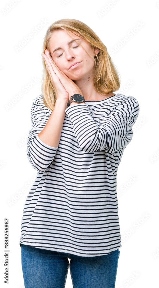 Beautiful young woman wearing stripes sweater over isolated background sleeping tired dreaming and posing with hands together while smiling with closed eyes.