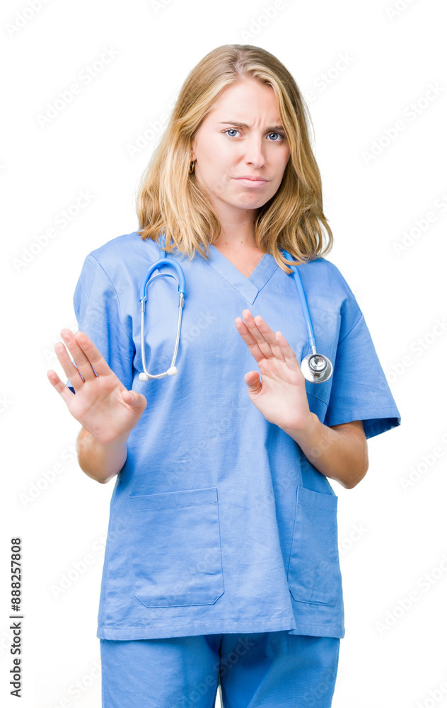 Beautiful young doctor woman wearing medical uniform over isolated background disgusted expression, displeased and fearful doing disgust face because aversion reaction. With hands raised. Beautiful young doctor woman wearing medical uniform over isolated background disgusted expression, displeased and fearful doing disgust face because aversion reaction. With hands raised.