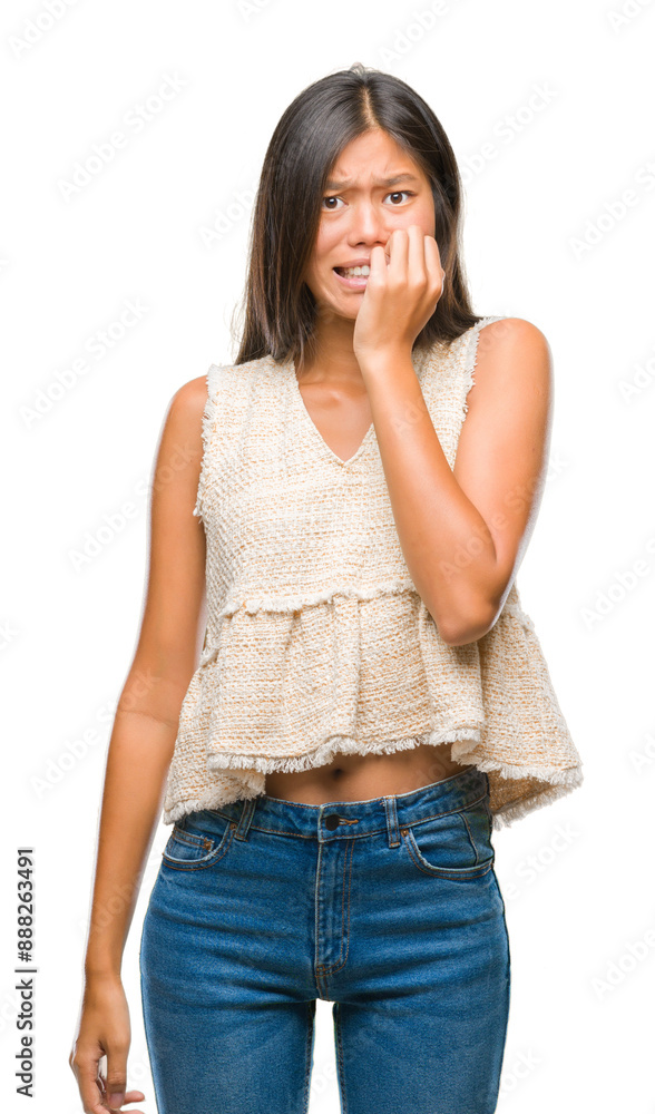 Obraz premium Young asian woman over isolated background looking stressed and nervous with hands on mouth biting nails. Anxiety problem.