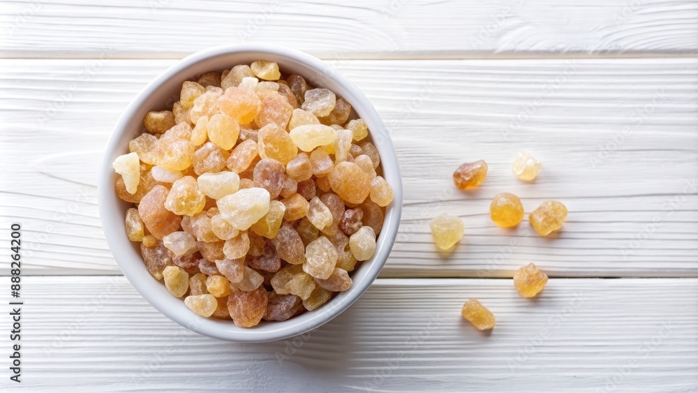 Top View of a Bowl of Golden Brown Resin on a White Wooden Surface, resin, amber, frankincense, natural Top View of a Bowl of Golden Brown Resin on a White Wooden Surface, resin, amber, frankincense, natural