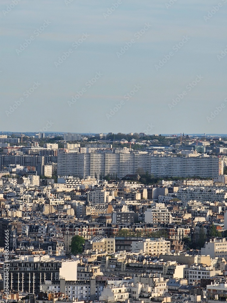 Obraz premium Paris, France - April 12, 2024: Aerial view of Paris skyline with dense urban sprawl and modern skyscrapers, Ile de France, France. Amazing mix between modern skyscraoers and old buildings.
