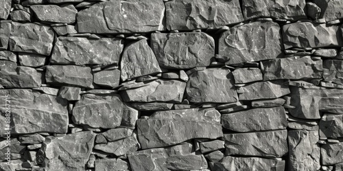 Ultra HD image of a small, dark gray stone wall with neutral lighting and textured details photo