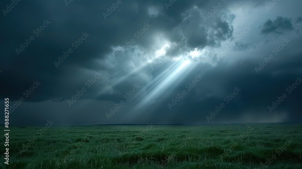 The image showcases sunbeams breaking through dense, dark clouds, illuminating the lush green field below, conveying a sense of hope and serenity amid a stormy sky. The image showcases sunbeams breaking through dense, dark clouds, illuminating the lush green field below, conveying a sense of hope and serenity amid a stormy sky.