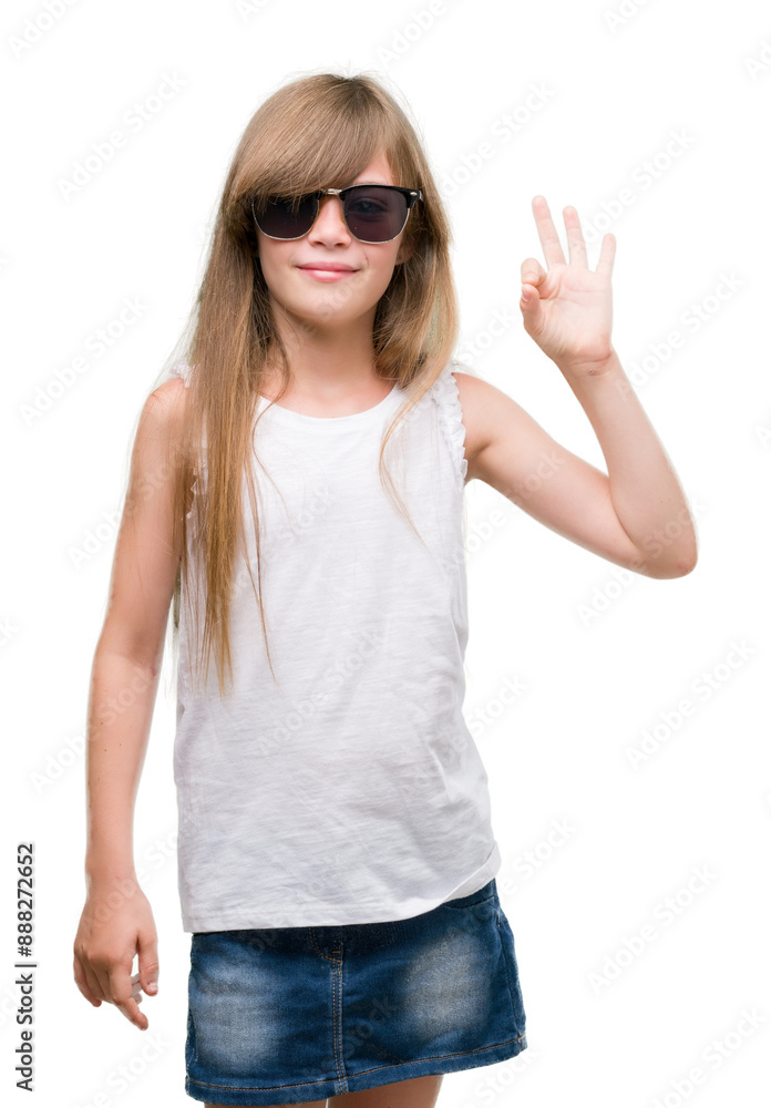 Young blonde toddler wearing sunglasses doing ok sign with fingers, excellent symbol Young blonde toddler wearing sunglasses doing ok sign with fingers, excellent symbol