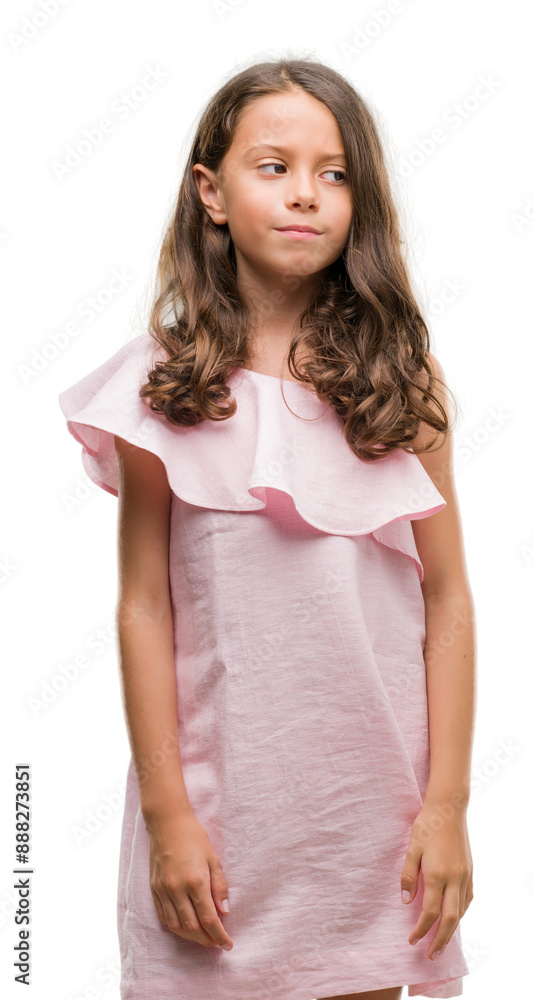 Brunette hispanic girl wearing pink dress smiling looking side and staring away thinking. Brunette hispanic girl wearing pink dress smiling looking side and staring away thinking.