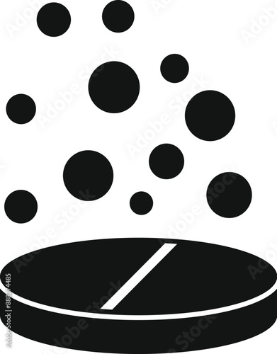Black effervescent tablet is dissolving in water, releasing many bubbles