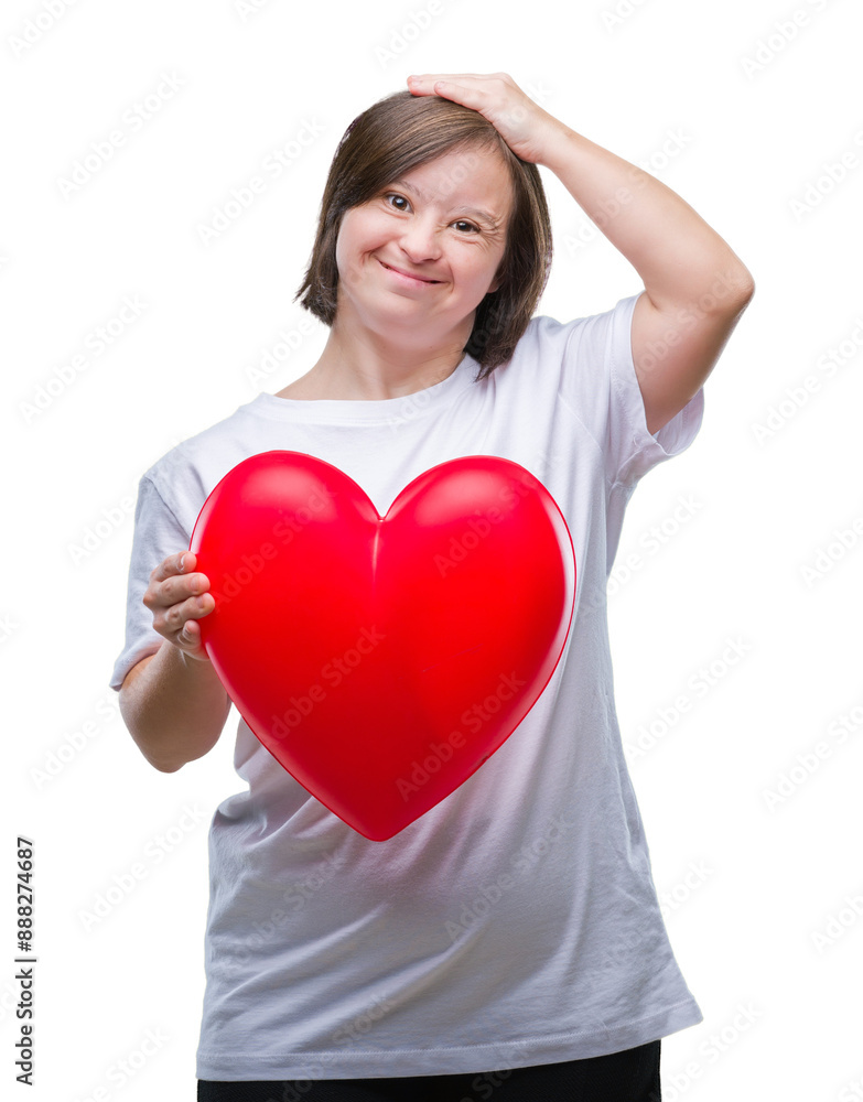 Young adult woman with down syndrome holding red heart over isolated background stressed with hand on head, shocked with shame and surprise face, angry and frustrated. Fear and upset for mistake. Young adult woman with down syndrome holding red heart over isolated background stressed with hand on head, shocked with shame and surprise face, angry and frustrated. Fear and upset for mistake.