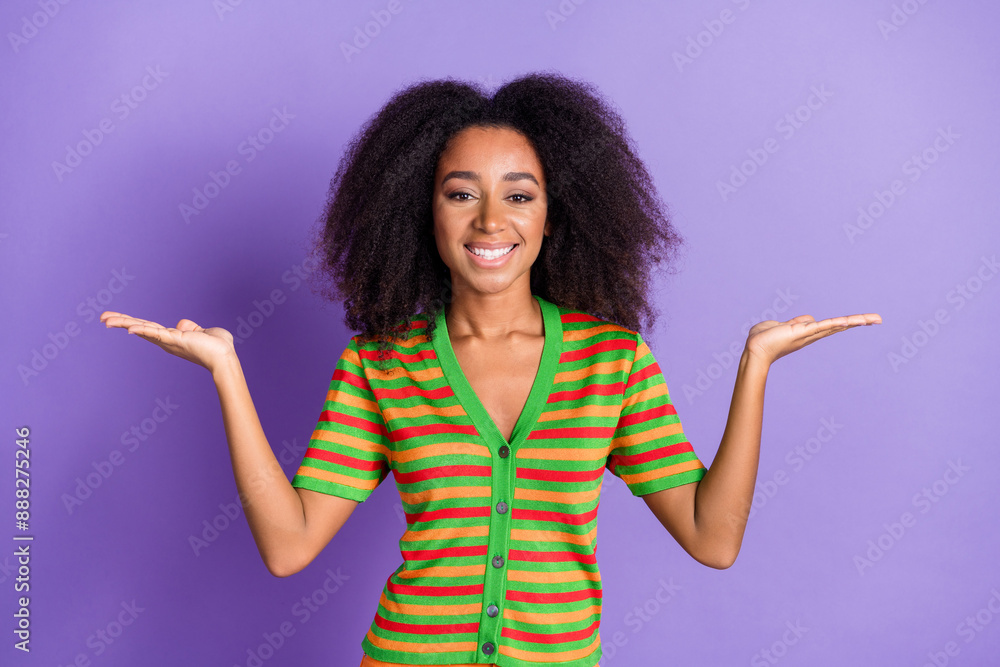 Photo of charming positive woman wear striped shirt comparing arms empty space isolated violet color background Photo of charming positive woman wear striped shirt comparing arms empty space isolated violet color background