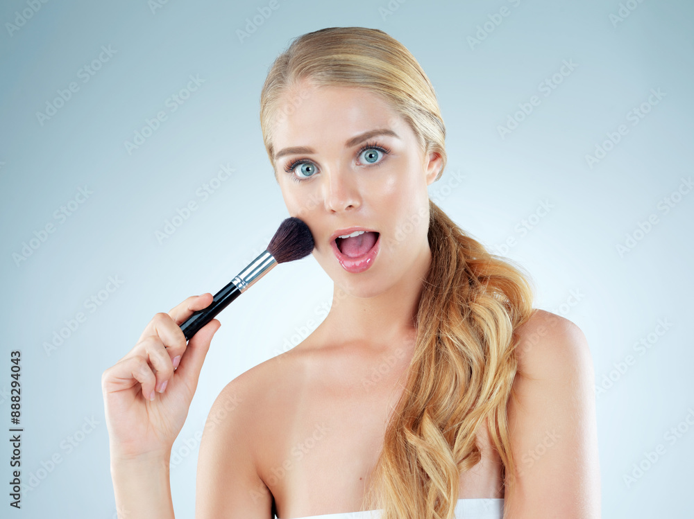 Surprise, woman and portrait with makeup brush in studio for cosmetic, beauty and foundation of aesthetic. Female person, wow and salon tools for glamour, transformation and glow on blue background Surprise, woman and portrait with makeup brush in studio for cosmetic, beauty and foundation of aesthetic. Female person, wow and salon tools for glamour, transformation and glow on blue background