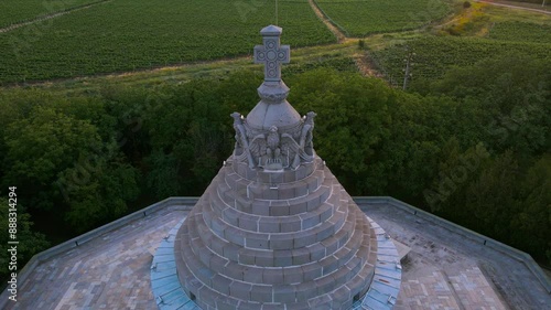 Aerial view of The Mausoleum of  Heroes of World War I from Marasesti, Romania. Photography was taken from a drone at a lower altitude at sunset, flying backwards with the building in the view.