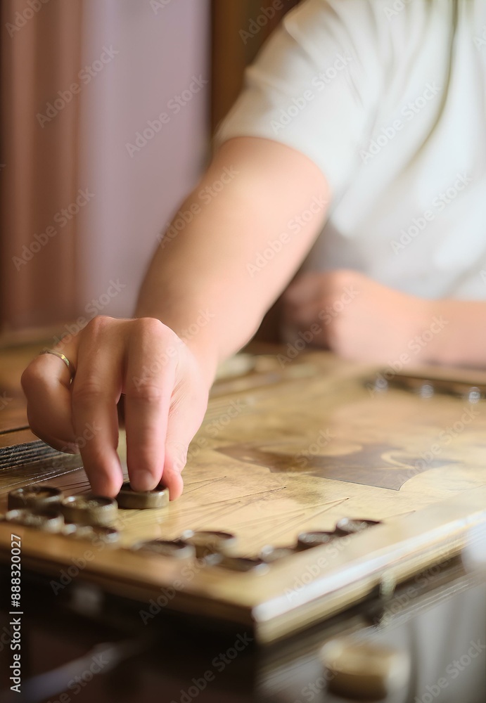 Fototapeta premium A Caucasian individual delighting in a game of checkers, a timeless tabletop game