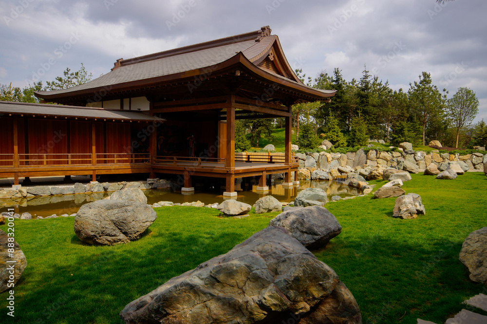 A beautiful Japanese garden with a pond and Tahoto Pagoda in the distance. Japanese garden in the public park of the city of Krasnodar, Russia.
