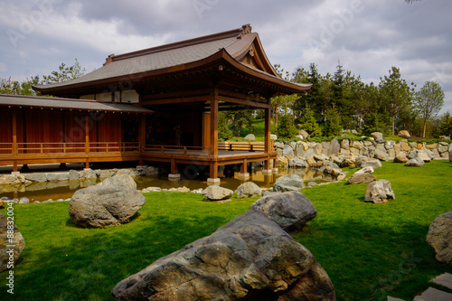 A beautiful Japanese garden with a pond and Tahoto Pagoda in the distance. Japanese garden in the public park of the city of Krasnodar, Russia.