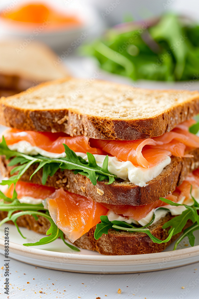A sandwich with ham and lettuce is stacked on top of another sandwich A sandwich with ham and lettuce is stacked on top of another sandwich