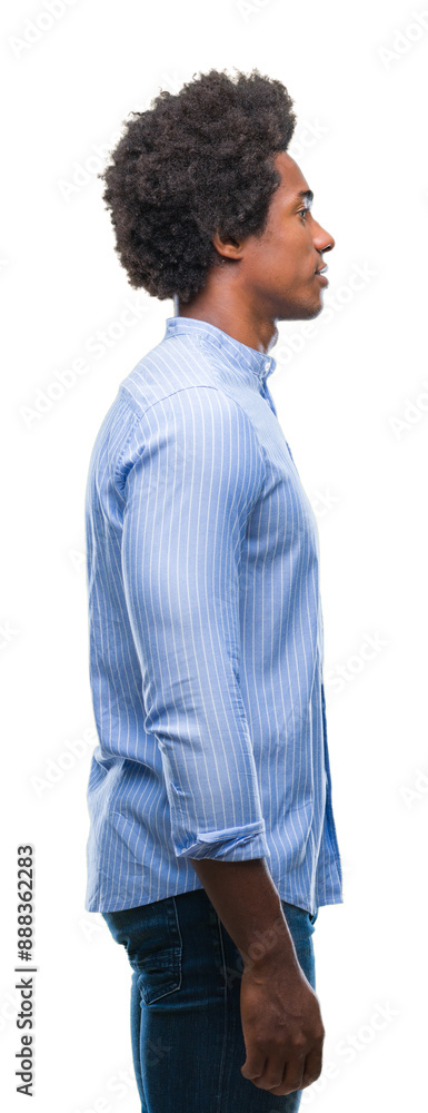 Afro american man over isolated background looking to side, relax profile pose with natural face with confident smile. Afro american man over isolated background looking to side, relax profile pose with natural face with confident smile.