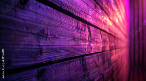 A wooden wall illuminated from below with neon purple light