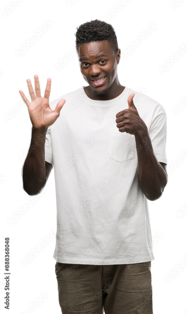 Young african american man wearing white t-shirt showing and pointing up with fingers number six while smiling confident and happy. Young african american man wearing white t-shirt showing and pointing up with fingers number six while smiling confident and happy.