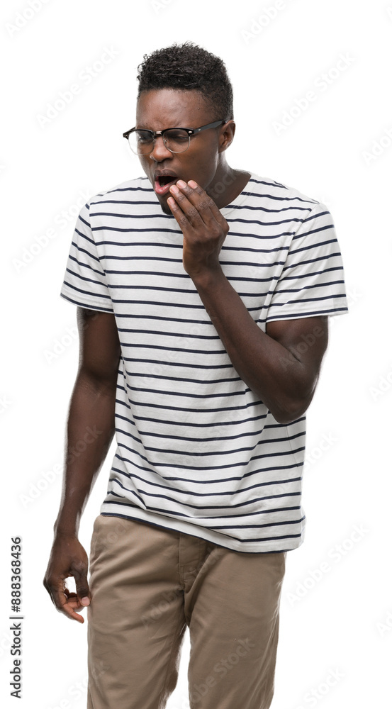 Young african american man wearing glasses and navy t-shirt touching mouth with hand with painful expression because of toothache or dental illness on teeth. Dentist concept. Young african american man wearing glasses and navy t-shirt touching mouth with hand with painful expression because of toothache or dental illness on teeth. Dentist concept.