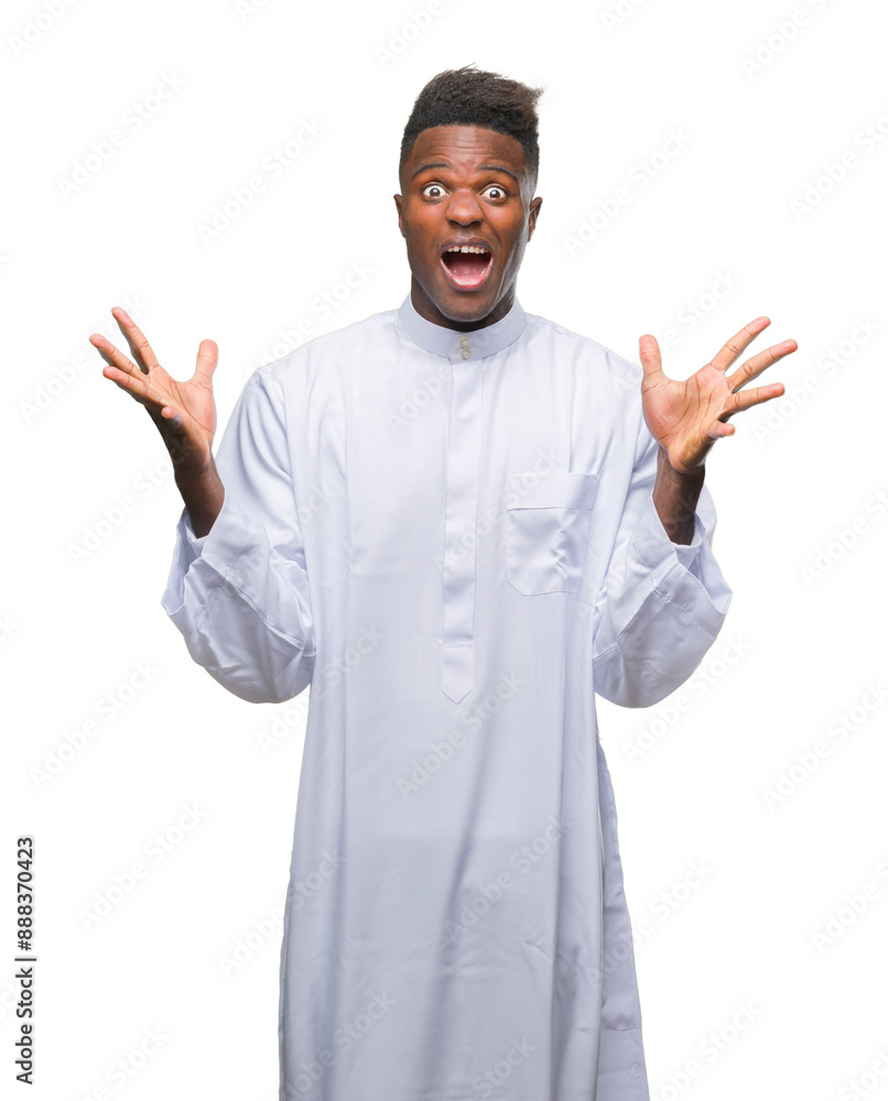 Young arabic african man wearing traditional djellaba over isolated background celebrating crazy and amazed for success with arms raised and open eyes screaming excited. Winner concept Young arabic african man wearing traditional djellaba over isolated background celebrating crazy and amazed for success with arms raised and open eyes screaming excited. Winner concept